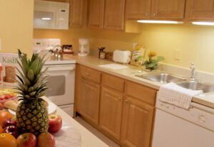 A kitchen with wooden cabinets and white appliances.