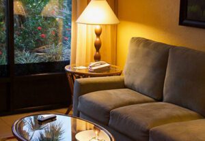 A living room with a couch and lamp on the table