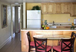 A kitchen with a table and chairs in it