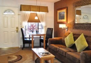 A living room with brown furniture and a table