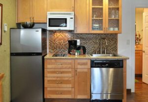 A kitchen with wooden cabinets and stainless steel appliances.