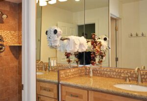 A bathroom with two sinks and a large mirror.