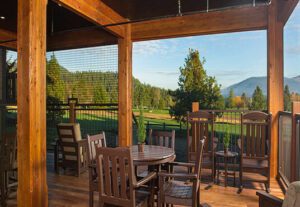 A wooden table and chairs on top of a deck.