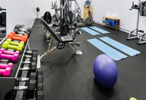 A gym with many different equipment and a ball