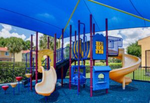 A playground with many different types of play equipment.