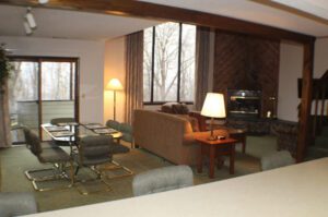 Living room with dining table and fireplace.