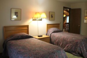 Two twin beds in a hotel room.