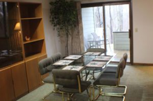 Dining room with glass table and chairs.