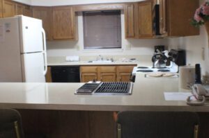 Kitchen counter with white appliances and cabinets.