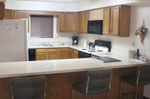 Kitchen island with chairs and appliances.