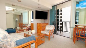 Living room with balcony and wicker furniture.