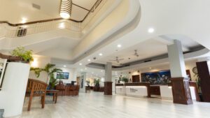 Hotel lobby with white walls and wood accents.