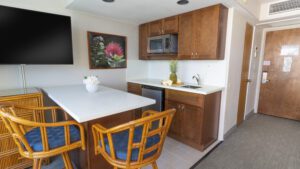 Kitchenette with bar stools and a pineapple.