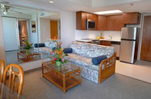 Living room with sofa, coffee table, and kitchen.