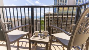 Two chairs with coffee and ocean view.