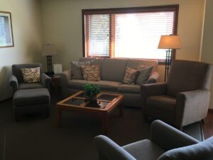 Living room with couch, chairs, and coffee table.