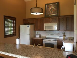 Kitchen with white appliances and wood cabinets.