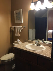 Bathroom vanity with sink and toilet.