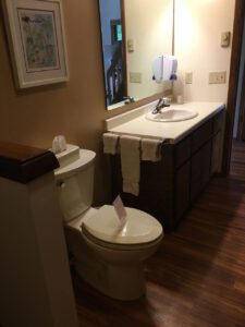 White toilet and sink in bathroom.