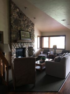 Living room with stone fireplace and couch.