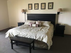 King bed in a hotel room with artwork.