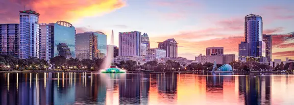 Orlando skyline at sunset with fountain.