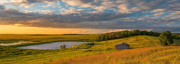 A small cabin on a grassy hill.