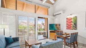 Bright living room with balcony and furniture.