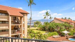 Resort with palm trees and mountain view.