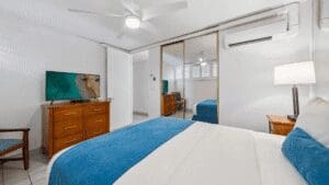 Modern bedroom with blue and white decor.