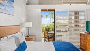 Hotel room with balcony and ocean view.