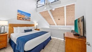 Modern bedroom with skylight and ceiling fan.