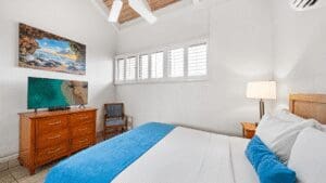 Cozy bedroom with blue accents and art.