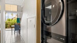 Laundry area with balcony view and seating.